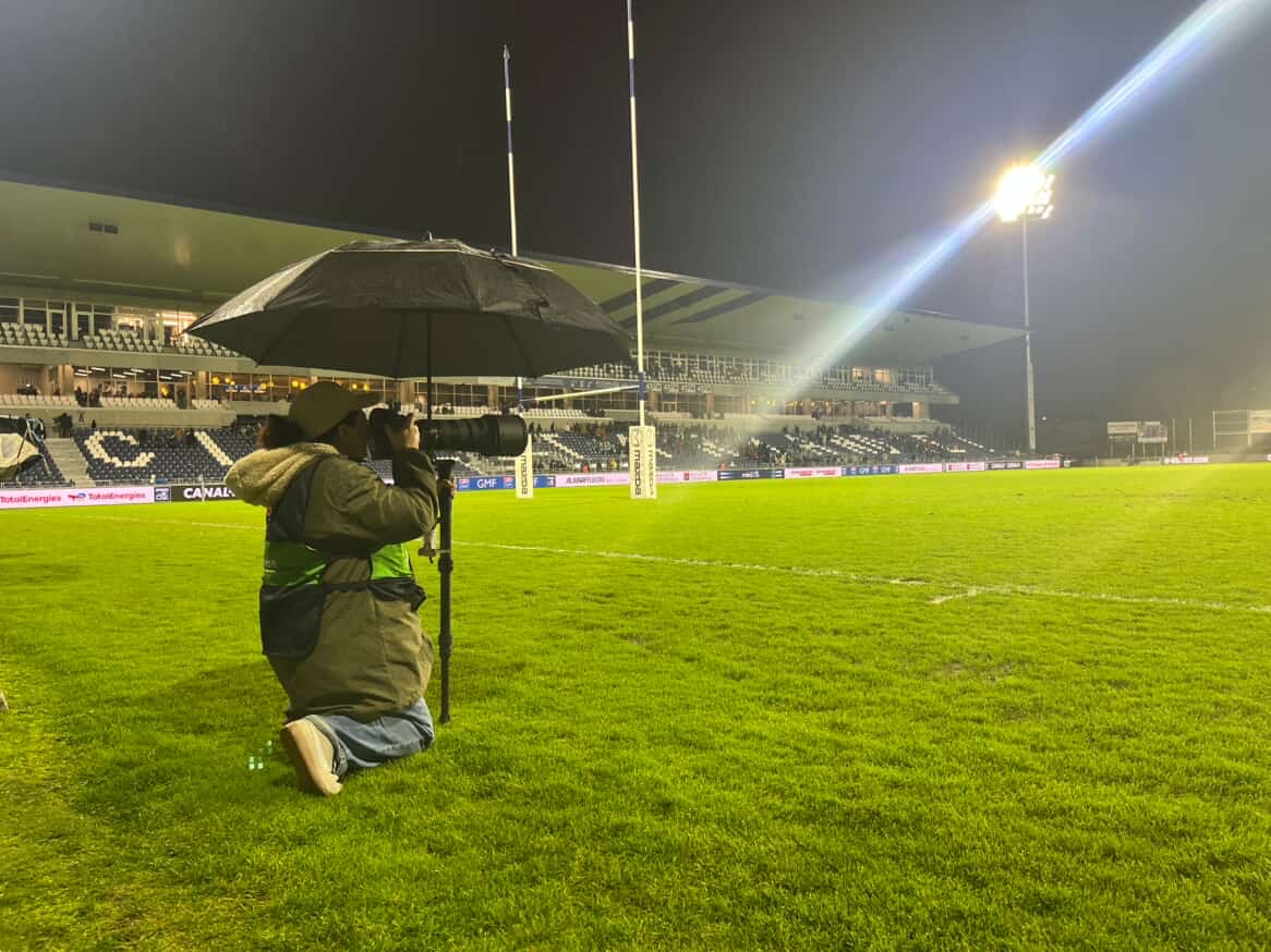 Maëlys en reportage photo sous la pluie, lors d'un match de rugby professionnel